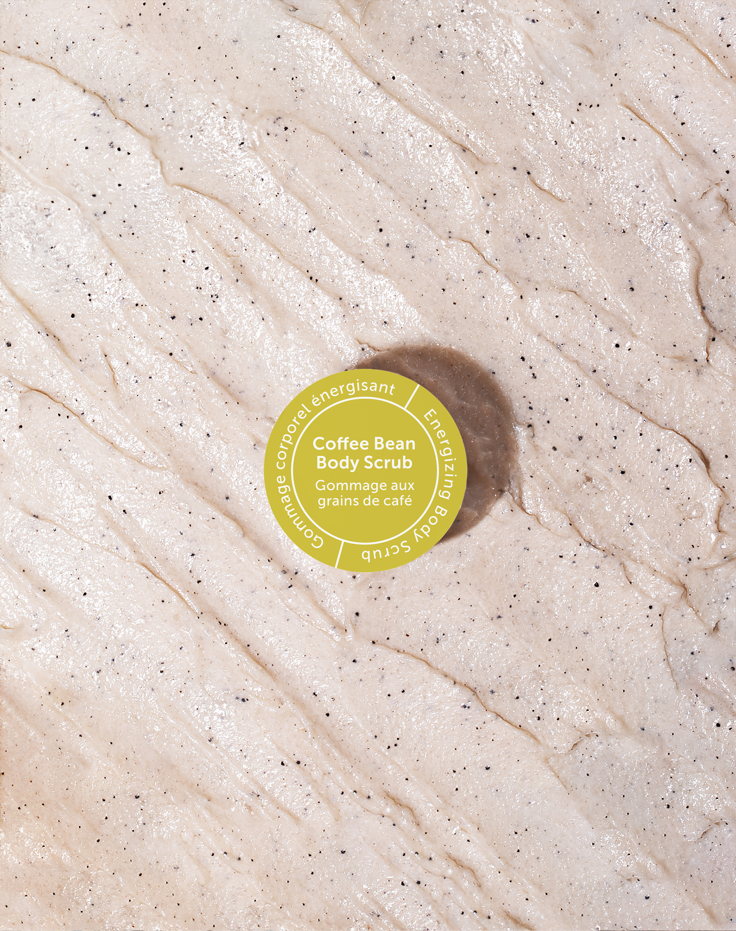 Danielle Gracioso Graphic Designer Vancouver BC Canada – Close-up texture of the Coffee Bean Body Scrub spread out, highlighting the natural exfoliating granules. Top label sticker designed by Danielle Gracioso.