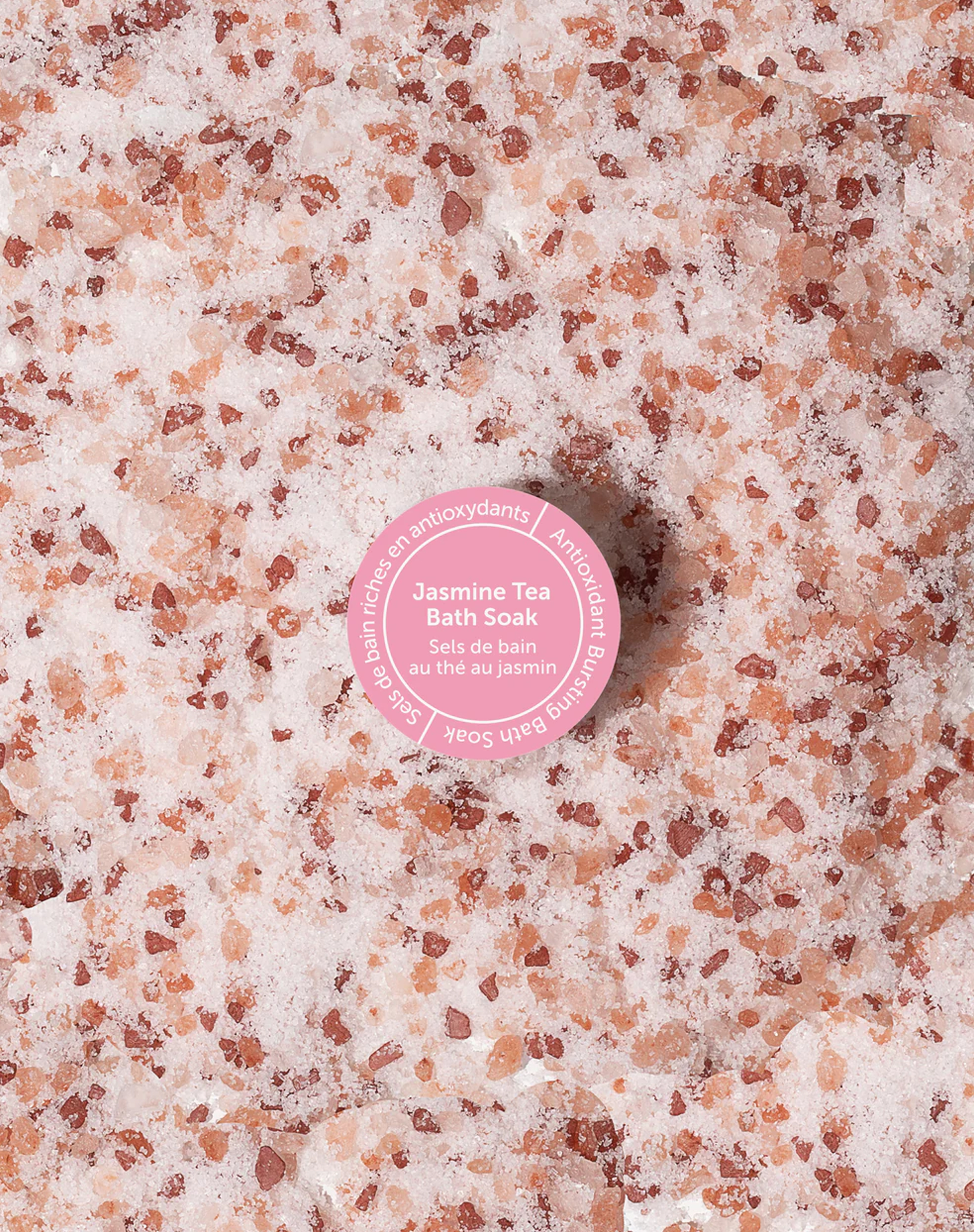 Danielle Gracioso Graphic Designer Vancouver BC Canada – Close-up texture shot of Jasmine Tea Bath Soak crystals, featuring the pink round scent sticker. Styled and photographed by Danielle Gracioso.